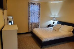 a bedroom with a large bed and a window at Nice and cozy home for a business or family stay. in Johnstown