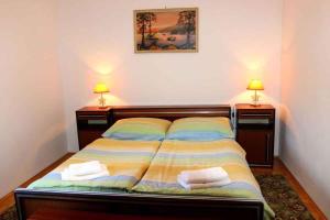 a bedroom with a bed with two night stands and two lamps at Three-Bedroom Apartment in Novi Vinodolski I in Povile