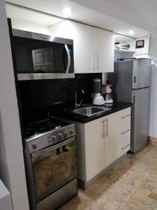 A kitchen or kitchenette at Room in Guest room - Mono-local apartment type private garden Boca Chica resort