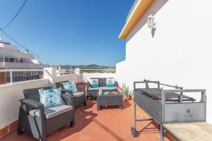 a balcony with chairs and furniture on a building at Pondarosa Penthouse 55 - Costa CarpeDiem in Calpe