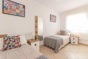Postel nebo postele na pokoji v ubytování Pondarosa Penthouse 55 - Costa CarpeDiem
