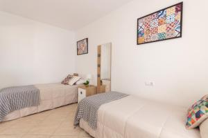 Postel nebo postele na pokoji v ubytování Pondarosa Penthouse 55 - Costa CarpeDiem