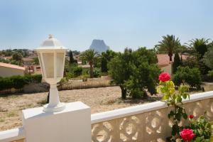 a white lamp on a white balcony with a view of the mountain at Villa Canuta De Ifach - Costa CarpeDiem in Calpe