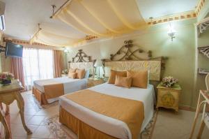 Postel nebo postele na pokoji v ubytování Villa las Margaritas Plaza Cristal