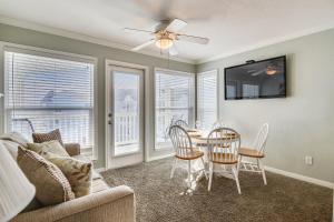 a living room with a dining room table and chairs at Seascape 2309 Condo in Galveston