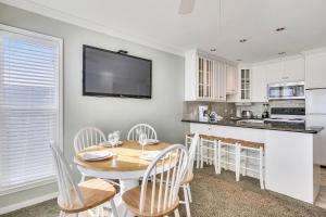 a kitchen and dining room with a table and chairs at Seascape 2309 Condo in Galveston