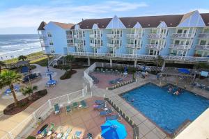 an aerial view of a hotel with a pool and the ocean at Seascape 2309 Condo in Galveston