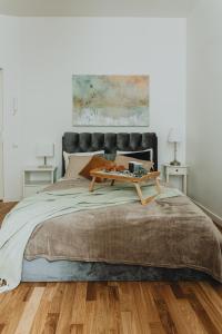 a bedroom with a bed with a table on it at Residential Barona Apartments in Riga Centre in Rīga