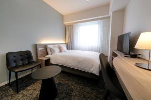 Postel nebo postele na pokoji v ubytování Glocal Hotel Itoshima
