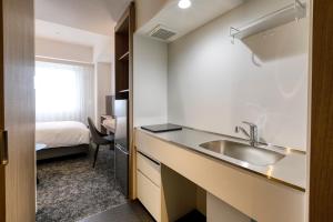 Postel nebo postele na pokoji v ubytování Glocal Hotel Itoshima