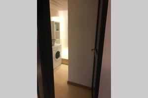 a view of a laundry room with a washing machine at Bel appartement neuf équipé au pied des pistes du HONHECK in La Bresse