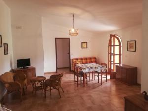 a living room with a table and chairs and a couch at L' Agrumeto in Palmi
