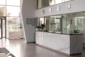 a lobby with a counter with plates on it at Hotel Joel in Novalja