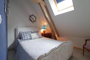 a bedroom with a bed in a attic with a window at Tante Pim in Neuilly-sur-Eure +57 photos
