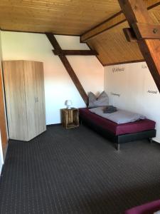 a bedroom with a bed and a wooden ceiling at Lissy‘s alte Schmiede in Kleinwerther