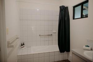 a bathroom with a bath tub, toilet and sink at Yallingup Forest Resort in Yallingup