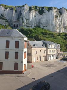a group of buildings in front of a mountain at O'2 cailloux in Le Tréport