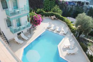 an overhead view of a swimming pool with chairs and a building at Silent Turkuaz Hotel in Sarigerme