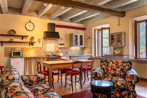 a kitchen with a table and chairs in a room at DIMORE ANTICHE in Ala