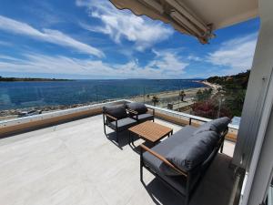 a balcony with a table and chairs and a view of the ocean at Apartment Danijela No. 2 in Novalja