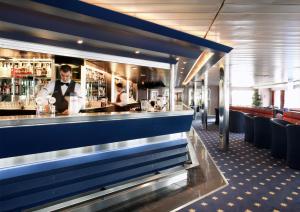 a bar with a man standing behind a counter at DFDS Mini Cruise "Newcastle - Amsterdam - Newcastle" in Newcastle upon Tyne