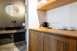 a kitchen with a sink and a counter with a mirror at Omilos Beachfront House in Parikia