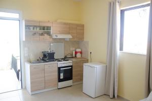 a small kitchen with a stove and a refrigerator at Erato Agios Nikolaos Appartment in Agios Nikolaos