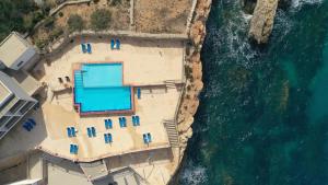 an aerial view of a building on the beach next to the ocean at Paradise Bay Resort in Mellieħa