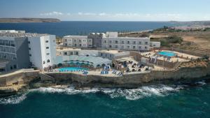 an aerial view of a resort on the ocean at Paradise Bay Resort in Mellieħa