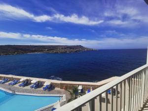 a view of the ocean from the balcony of a resort at Paradise Bay Resort in Mellieħa