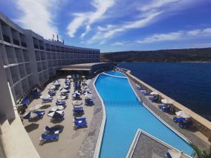 an overhead view of the pool at a resort at Paradise Bay Resort in Mellieħa