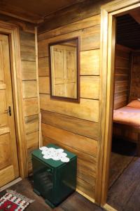 a wooden cabin with a green stool in a room at Збориште in Brdo