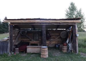 a shed with a bed and a stove in a field at Збориште in Brdo