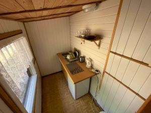 a small kitchen with a sink in a small room at Domki letniskowe blisko plaży- Park Jantar in Jantar