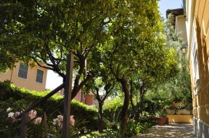 a garden with trees and bushes next to a building at Locanda Villa Moderna in Genoa