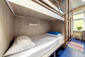 two bunk beds in a room with a table at Никитская капсула - сердце Москвы in Moscow