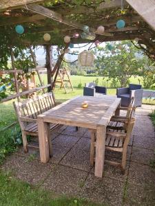 a wooden table and chairs under a tent at Haus Fernblick in Birkfeld