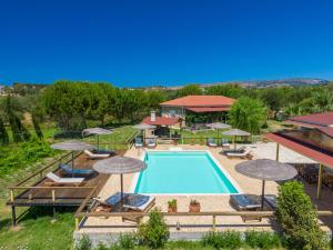 an overhead view of a swimming pool with umbrellas at Aggelina's Apartments in Xi