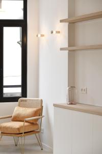 a rattan chair in a kitchen with a window at Urban Walls in Brussels