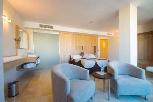 a hotel room with two chairs and a bed at La Sort Boutique Hotel in Moraira