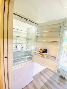 an empty refrigerator with its door open at SUNNY SWEET HOME OLGA in Torrevieja