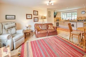 a living room with a couch and a chair at Host & Stay - Heron Cottage in Levisham