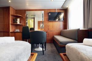 a living room with a couch and a tv at DFDS Mini Cruise "Newcastle - Amsterdam - Newcastle" in Newcastle upon Tyne
