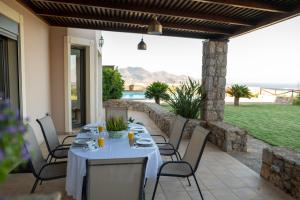 a table and chairs on a patio with a view at Villa Hestia in Agios Nikolaos