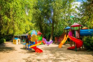 a playground with a bunch of play equipment in a park at Hotel Majestic Mamaia Half Board & All Inclusive in Mamaia