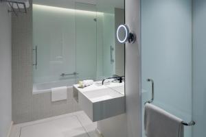 a bathroom with a white sink and a mirror at Staybridge Suites Al Khobar by IHG in Al Khobar