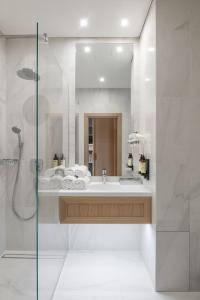 a bathroom with a sink and a shower at CALVARY Hotel & Restaurant Vilnius in Vilnius