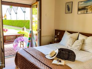 a bedroom with a bed with a hat and books on it at Pokoje gościnne Jolka in Łeba