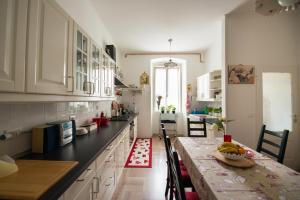 a kitchen with a table and a dining room at Antico Borgo Teresiano in Trieste