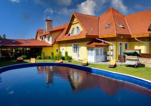 a house with a swimming pool in the yard at Kiev 365 Park Hotel in Kyiv